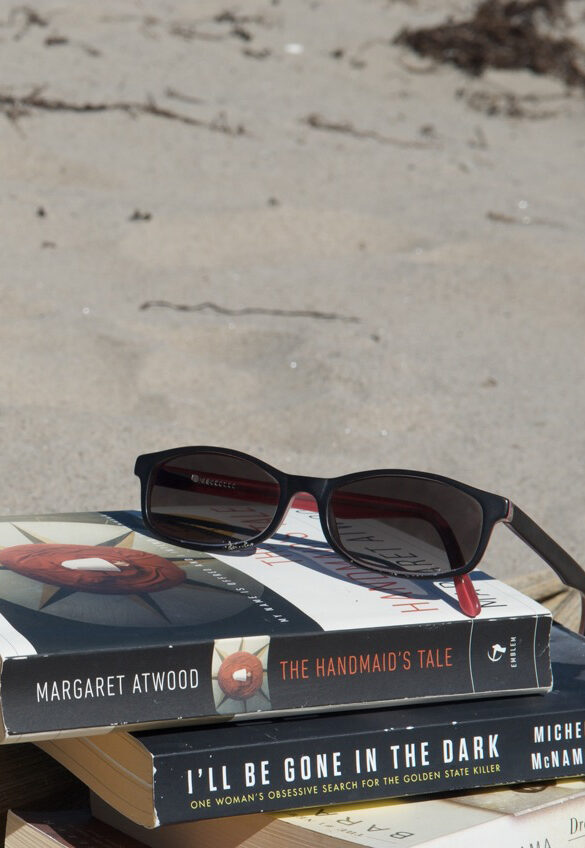 books and sunglasses on beach